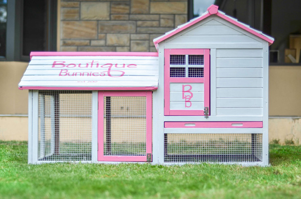 A large rabbit hutch painted with the Boutique Bunnies logo